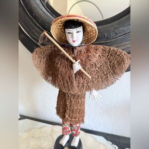 Vintage Asian doll on pedestal